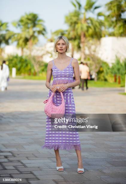 Lisa Hahnbück is seen wearing pink checkered top with fringes & maxi skirt Baum & Pferdgarten, Amina Muaddi heels in white, Miu Miu bag on March 29,...
