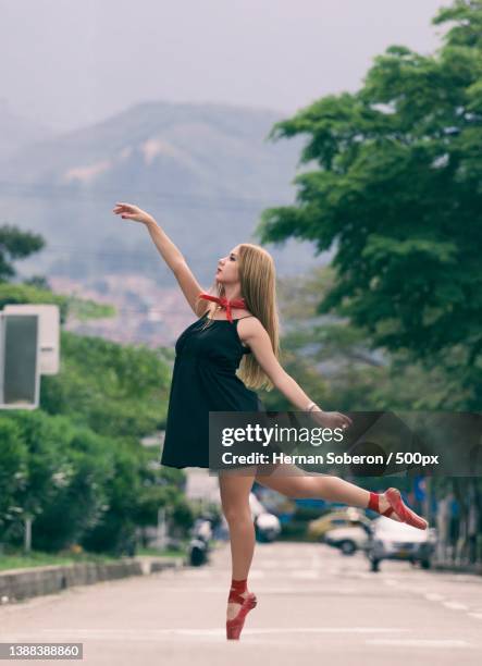 street of the dancer,full length of young woman dancing on road - bailarina stock pictures, royalty-free photos & images