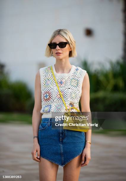 Lisa Hahnbück is seen wearing Mango sleeveless crochet top, the Attico denim skirt, Hermes Oran slides in blue & Hermès Kelly bag in yellow on March...