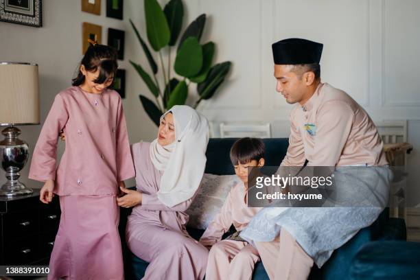 malaysian muslim family bonding and having good time celebrating hari raya aidilfitri at home - malayan ethnicity stock pictures, royalty-free photos & images