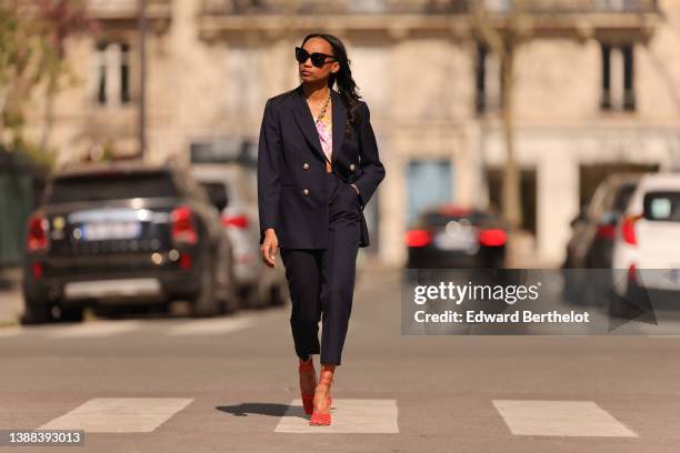 Emilie Joseph @in_fashionwetrust wears black sunglasses, a black oversized blazer jacket with gold buttons from LK Bennett London, matching black...