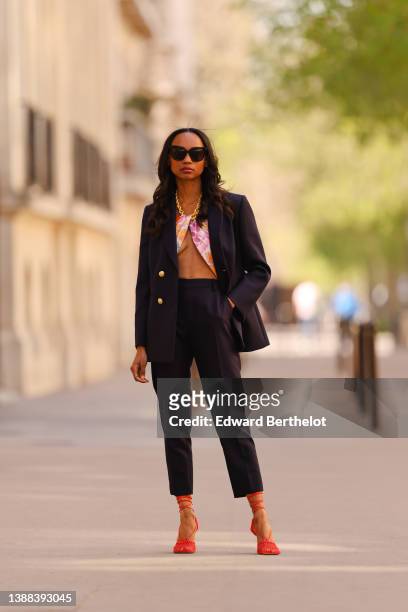 Emilie Joseph @in_fashionwetrust wears black sunglasses, a black oversized blazer jacket with gold buttons from LK Bennett London, matching black...