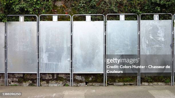 empty metal panels along a wall reserved for the display of political parties during the 2022 french presidential elections - election stock pictures, royalty-free photos & images