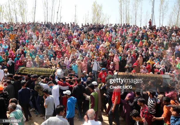 This image depicts death) Kashmiri people carry the coffins of slain Indian policeman Ishfaq Ahmad and his brother Umer Dar during their funeral...