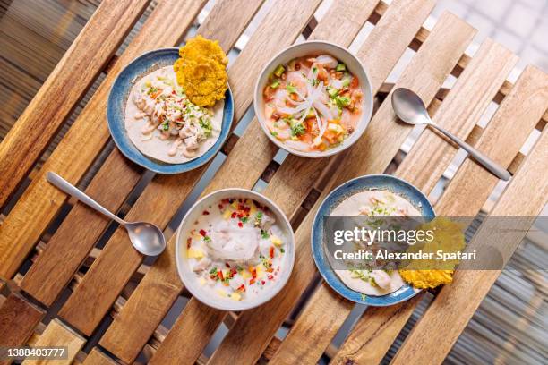 ceviche and tacos served on the table in a restaurant, directly above view - peruvian culture stockfoto's en -beelden