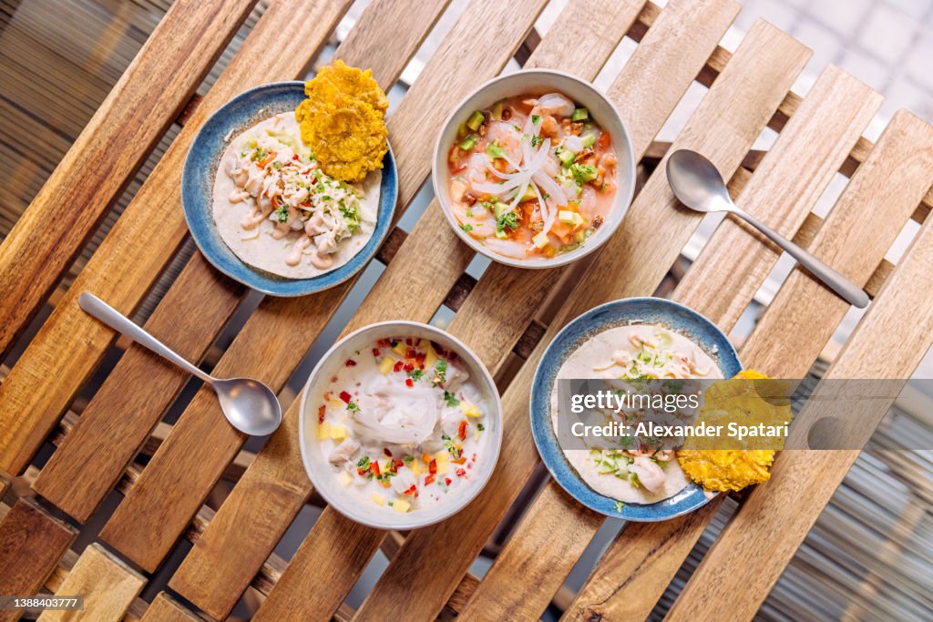 Ceviche and tacos served on the table in a restaurant, directly above view