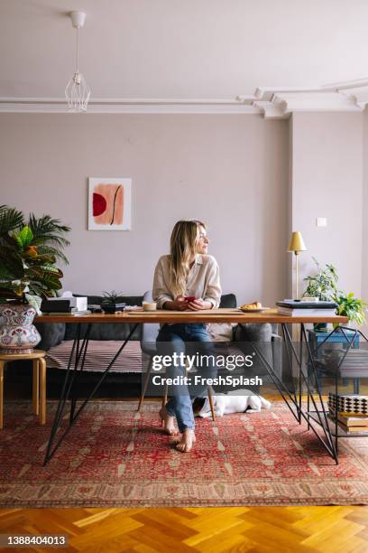 woman enjoying her morning at her home office - factory wide angle stock pictures, royalty-free photos & images