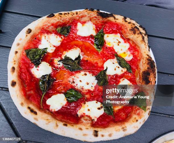 fresh pizza with basil tomato and mozzarella - cheese pizza stock-fotos und bilder