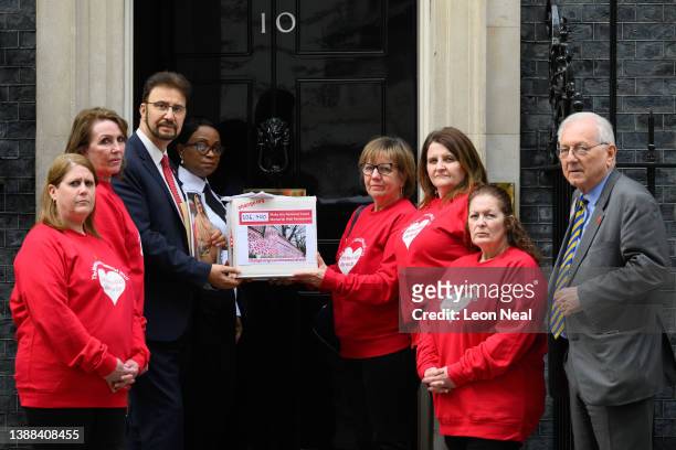 Group of campaigners hand in a petition to 10, Downing Street on the first anniversary of the creation of the Covid Memorial Wall, calling for it to...
