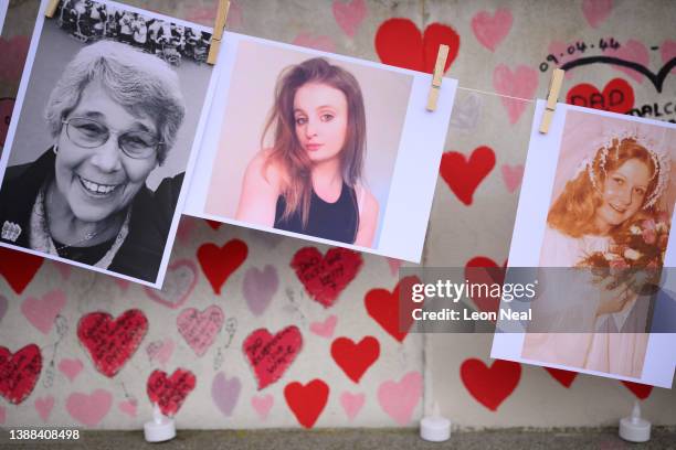 Photographs of some of those who died during the Covid-19 pandemic are seen on the first anniversary of the creation of the Covid Memorial Wall, on...
