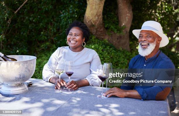 mature couple having fun doing a wine tasting outside in summer - south africa wine stock pictures, royalty-free photos & images