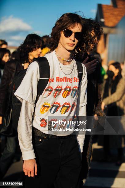Model Luke Sadler wears black sunglasses and a white The Rolling Stones tongue band t-shirt after the Gucci show during the Milan Fashion Week...