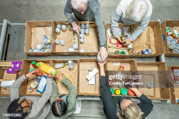 aerial view of volunteers packing - food bank stock pictures, royalty-free photos & images