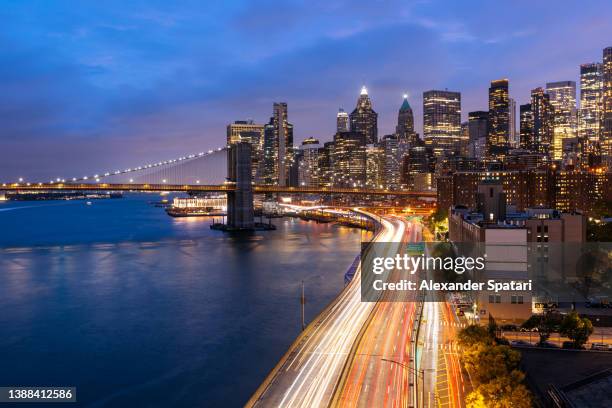 new york city skyline photographed with long exposure at dusk, high angle view, usa - new york city lights stock pictures, royalty-free photos & images