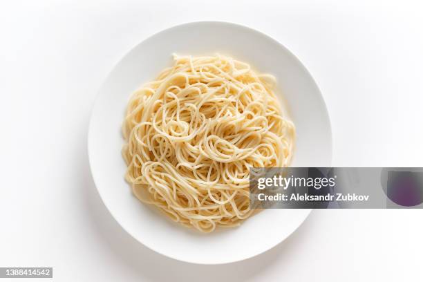 spaghetti or pasta on a ceramic plate, isolated on a white background or table. the concept of vegetarian and vegan food. food background. copy of the text space. - alimentos cocinados fotografías e imágenes de stock