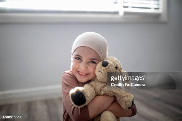 young cancer patient and her stuffed animal - childhood cancer stock pictures, royalty-free photos & images