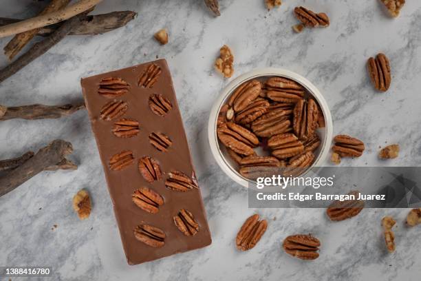 chocolate bar with walnut on a table with a classic decoration. - caramel block stock pictures, royalty-free photos & images