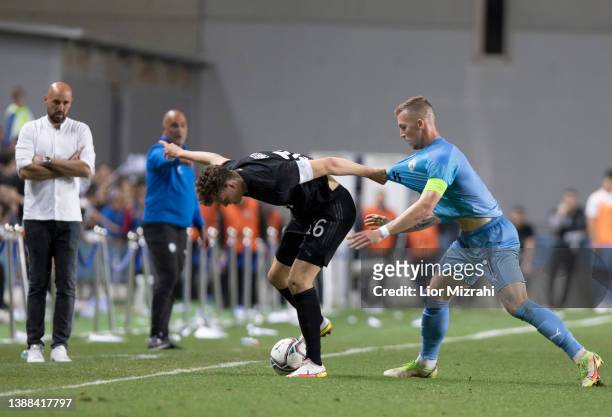 Eric Martel of Germany competes with Eden Karzev of Israel during the UEFA European Under-21 Championship Qualifier match between Israel U21 and...