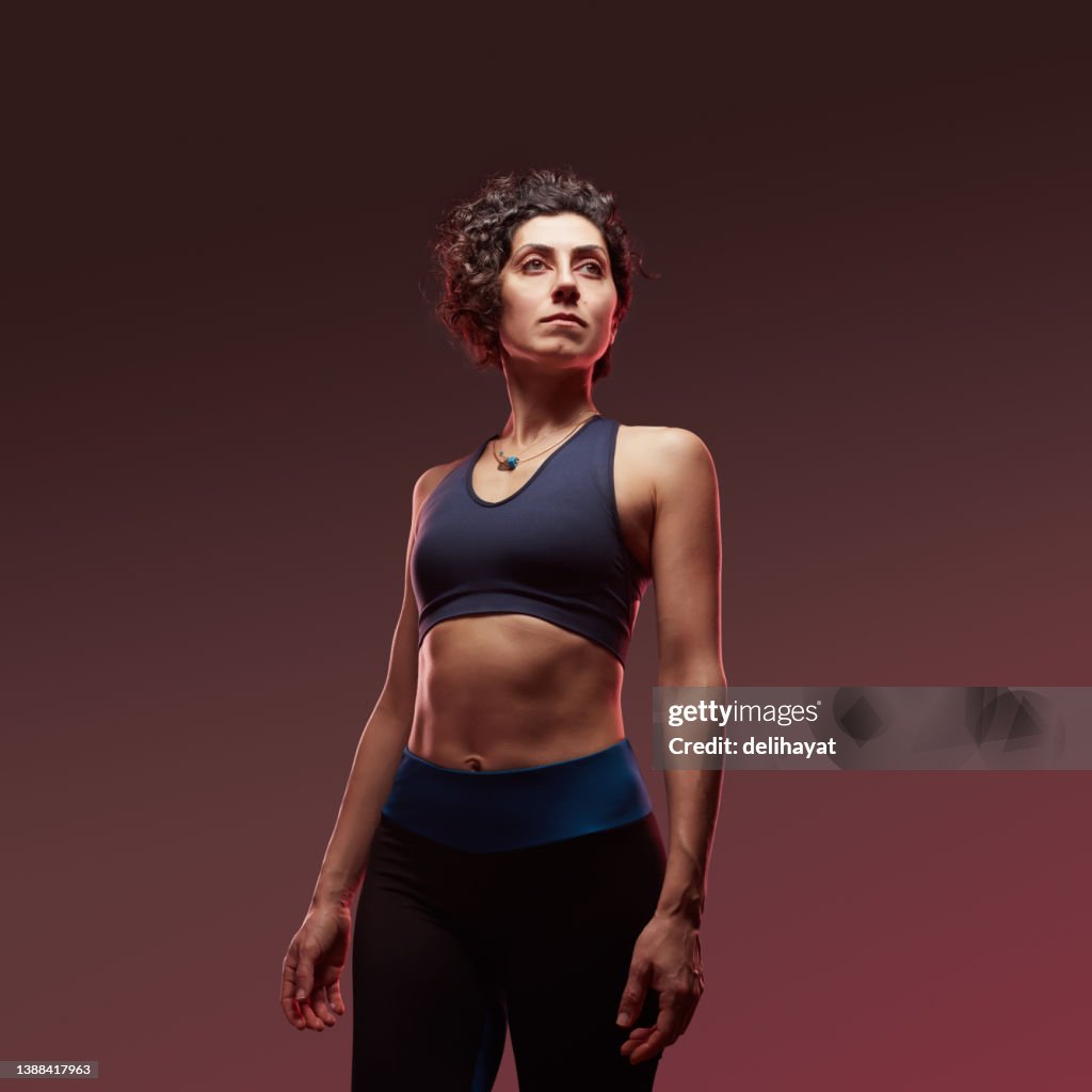 Strong confident athletic sportswoman standing