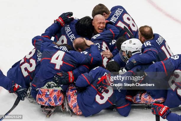 Jen Lee of Team United States celebrates with teammates after defeating Team Canada during the Para Ice Hockey Gold Medal game on day nine of the...