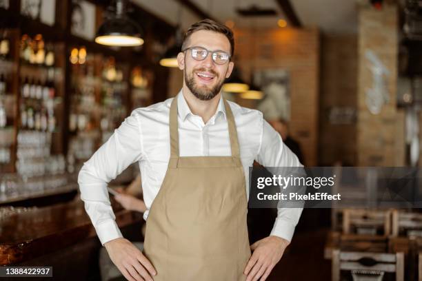 portrait of barista standing at coffee shop - servitör bildbanksfoton och bilder