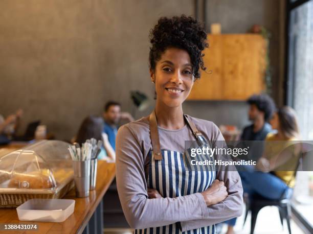happy waitress working at a cafe - apron stockfoto's en -beelden