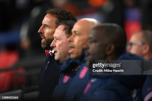 Gareth Southgate, Manager of England, Steve Holland, Assistant Manager of England and England coaches Paul Nevin and Chris Powell stand for the...