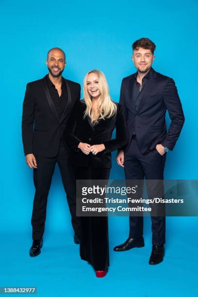 Presenters Marvin Humes, Emma Bunton and Roman Kemp pose backstage during a Concert for Ukraine at Resorts World Arena on March 29, 2022 in...