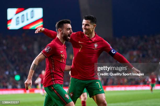 Bruno Fernandes of Portugal celebrates with Cristiano Ronaldo after scoring their side's first goal during the 2022 FIFA World Cup Qualifier knockout...