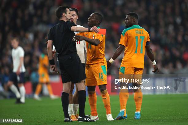 Serge Aurier of Cote D'Ivoire is shown a red card by match referee Erik Lambrechts during the international friendly match between England and Cote...