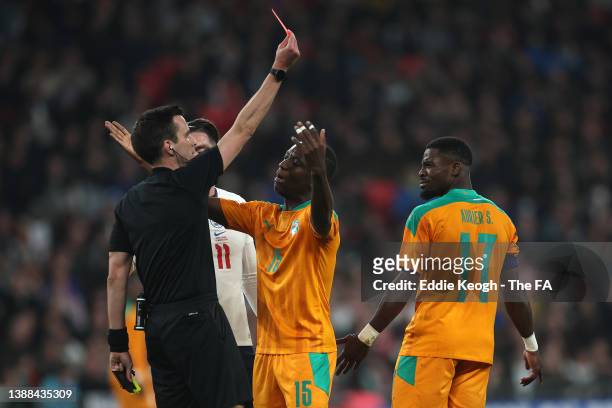 Serge Aurier of Cote D'Ivoire is shown a red card by match referee Erik Lambrechts during the international friendly match between England and Cote...