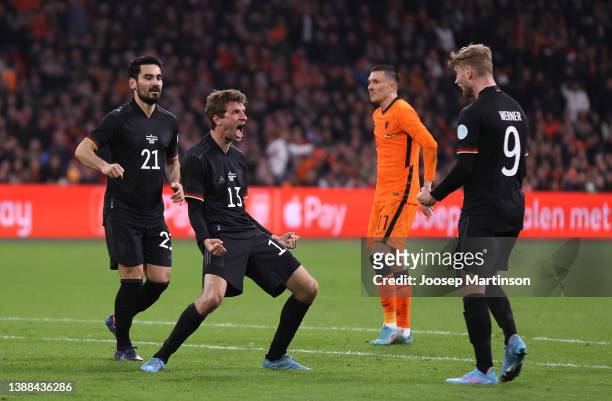 Thomas Mueller of Germany celebrates after scoring their side's first goal with Ilkay Gundogan and Timo Werner during the international friendly...