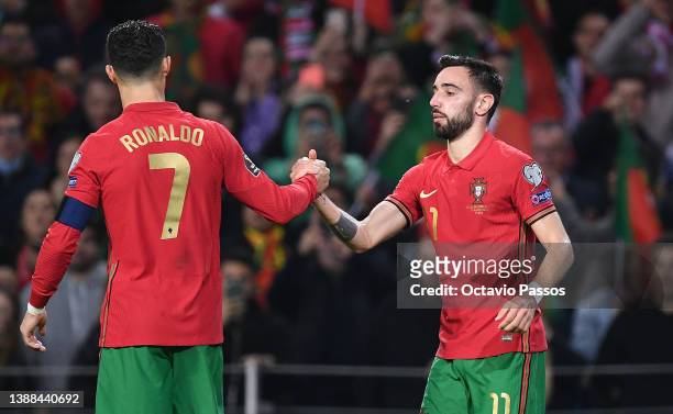 Bruno Fernandes celebrates with Cristiano Ronaldo of Portugal after scoring their team's second goal during the 2022 FIFA World Cup Qualifier...