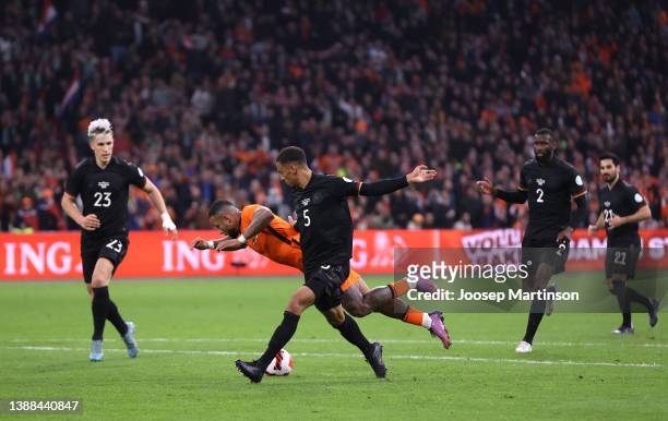 Memphis Depay of Netherlands is challenged by Thilo Kehrer of Germany leading to a penalty being awarded before it is disallowed by a VAR check...