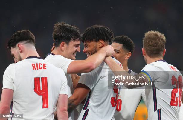 Tyrone Mings of England celebrates with teammate Harry Maguire after scoring their team's third goal during the international friendly match between...