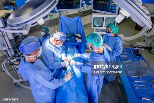 hospital operating theatre with medical team wearing ppe - bariatric stock pictures, royalty-free photos & images