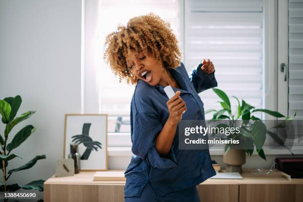 happy woman having fun in her bedroom - best song stock pictures, royalty-free photos & images