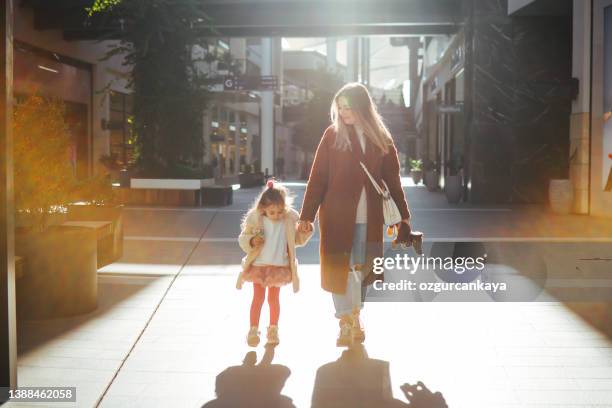 happy mother and daughter shopping - fashion kids stock pictures, royalty-free photos & images