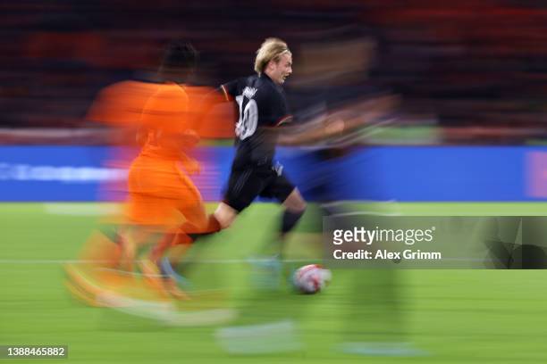Julian Brandt of Germany eludes Nathan Ake of Netherlands during the international friendly match between Netherlands and Germany at Johan Cruijff...