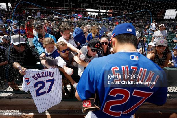 Seiya Suzuki of the Chicago Cubs signs autographs for fans before the MLB game against the Arizona Diamondbacks at Sloan Park on March 29, 2022 in...