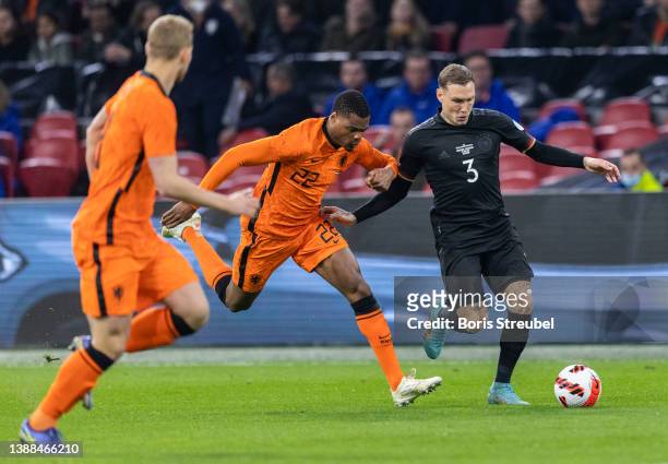 David Raum of Germany is challenged by Denzel Dumfries of the Netherlands during the international friendly match between Netherlands and Germany at...