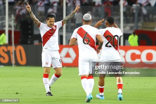 Gianluca Lapadula of Peru celebrates with teammates Miguel Trauco and Edison Flores after scoring the first goal of his team during the FIFA World...