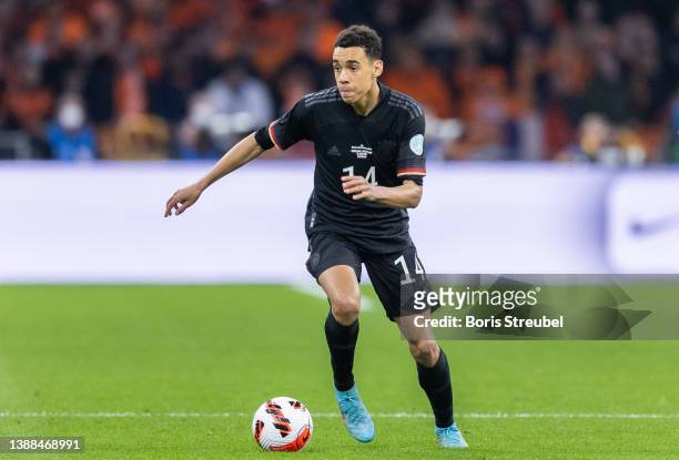 Jamal Musiala of Germany runs with the ball during the international friendly match between Netherlands and Germany at Johan Cruijff Arena on March...