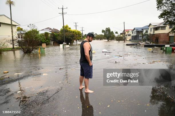 James Brady inspects flooding in his street on March 30, 2022 in Lismore, Australia. Evacuation orders have been issued for towns across the NSW...