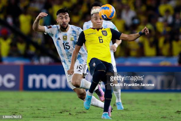 Byron Castillo of Ecuador fights for the ball with Nicolás González of Argentina during the FIFA World Cup Qatar 2022 qualification match between...