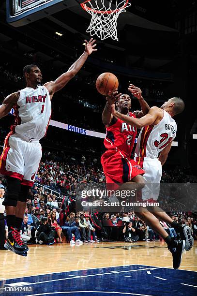 Joe Johnson of the Atlanta Hawks drives against Shane Battier of the Miami Heat on February 12, 2012 at Philips Arena in Atlanta, Georgia. NOTE TO...