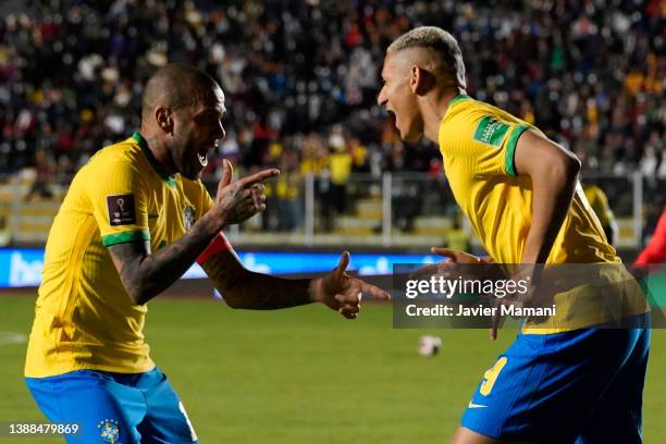 Richarlison of Brazil celebrates with teammate Dani Alves after scoring the fourth goal of his team during a match between Bolivia and Brazil as part...