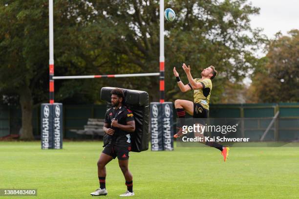 Jone Rova and George Bridge take part in a drill during a Crusaders Super Rugby training session at Rugby Park on March 30, 2022 in Christchurch, New...