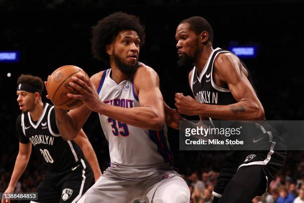 Kevin Durant of the Brooklyn Nets defends against Marvin Bagley III of the Detroit Pistons at Barclays Center on March 29, 2022 in New York City....