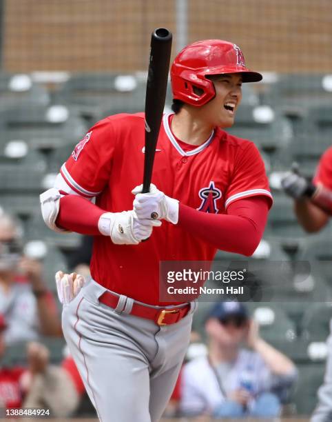 Shohei Ohtani of the Los Angeles Angels follows through on a swing during a spring training game against the Colorado Rockies at Salt River Fields at...